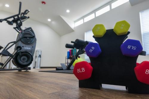 A rack of multi-colored dumbbells rests on the floor of the gym at the Medical Center RV Resort in Houston, Texas.