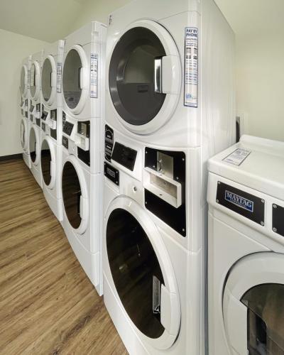 Stacked washers and dryers in the laundry room of the Medical Center RV Resort in Houston, Texas.